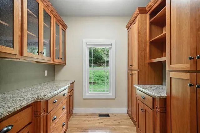 a kitchen with granite countertop cabinets and window