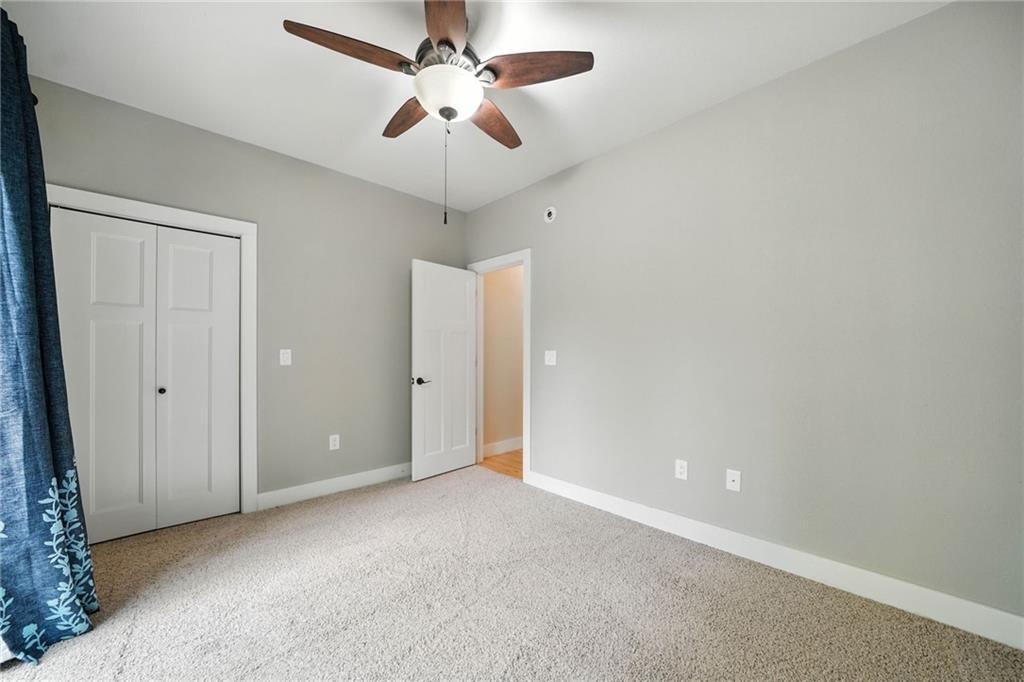 87 Dillons Lane Morganton, GA 30560 - Photo 18 of 42 an empty room with a chandelier fan and a ceiling fan