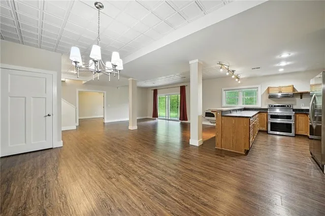 a view of a kitchen with stove and wooden floor