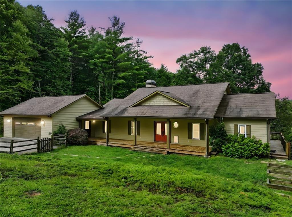 87 Dillons Lane Morganton, GA 30560 - Photo 3 of 42 a front view of a house with a garden