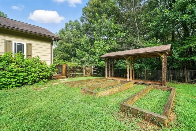 a view of a house with a yard and sitting area