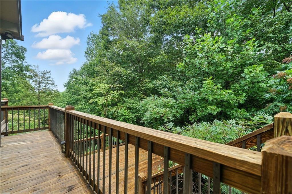 87 Dillons Lane Morganton, GA 30560 - Photo 36 of 42 a balcony with wooden floor and trees in the back