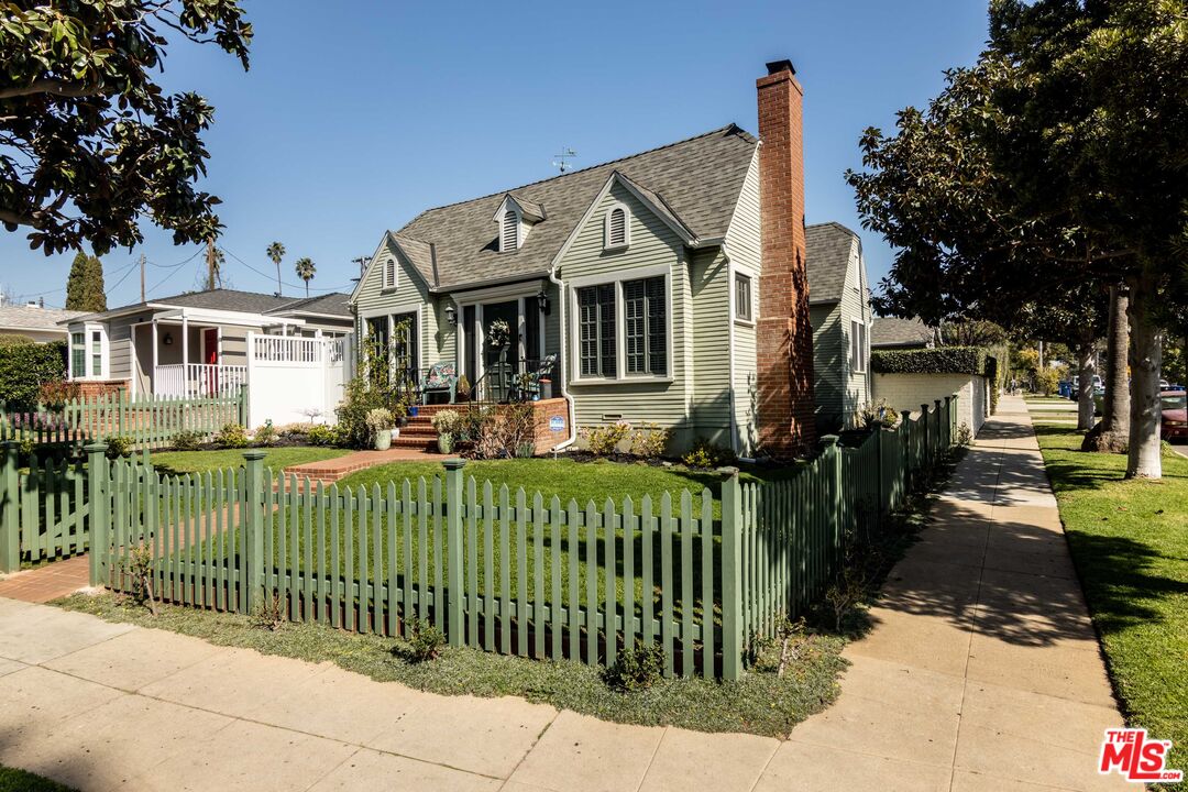 880 Wellesley Avenue Los Angeles, CA 90049 - Photo 1 of 29 a front view of a house with a garden and plants