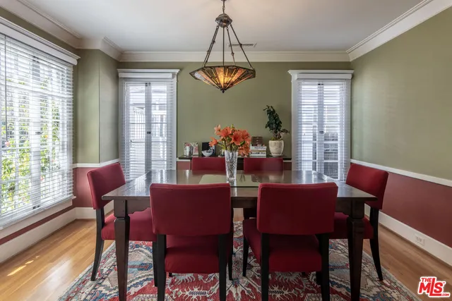 a dining room with furniture a rug and a chandelier