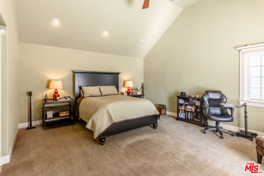 880 Wellesley Avenue Los Angeles, CA 90049 - Photo 15 of 29 a bedroom with a bed chair and a window