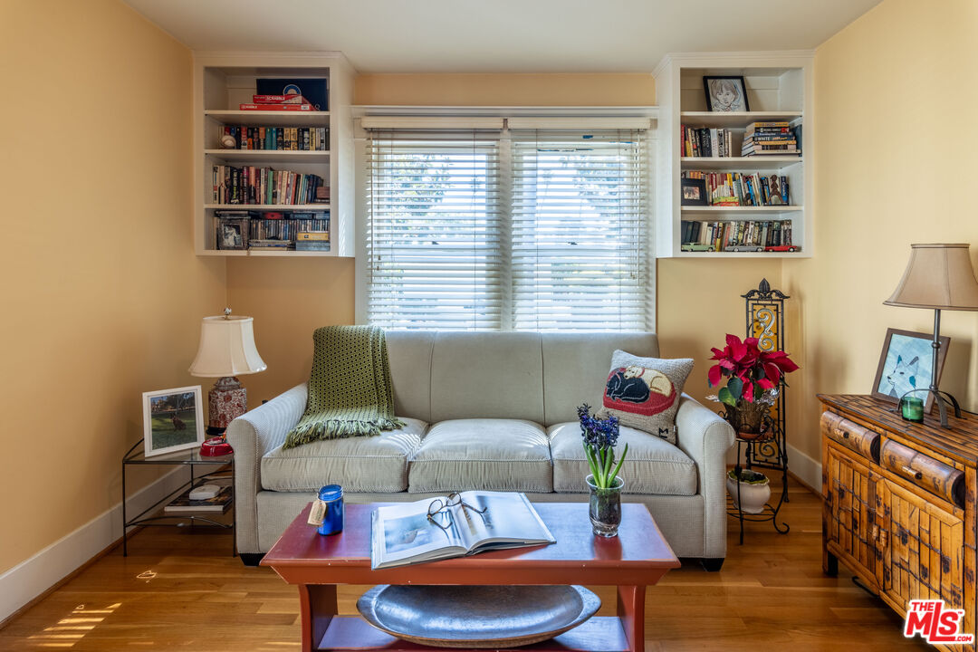 880 Wellesley Avenue Los Angeles, CA 90049 - Photo 20 of 29 a living room with furniture a bookshelf and a window