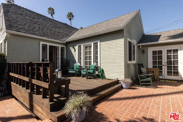 a table and chairs in front of a house