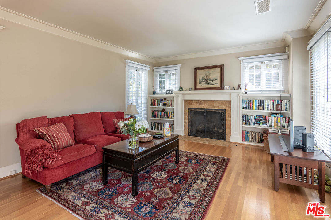 880 Wellesley Avenue Los Angeles, CA 90049 - Photo 4 of 29 a living room with furniture and a fireplace