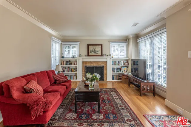 a living room with furniture fireplace and window