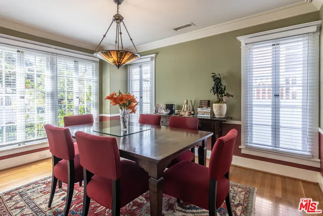 a dining room with furniture a chandelier and wooden floor