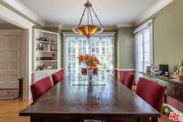 a view of a dining room with furniture a chandelier and wooden floor
