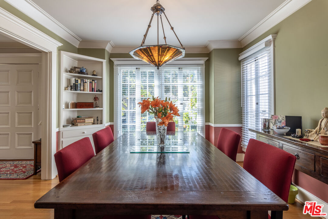 880 Wellesley Avenue Los Angeles, CA 90049 - Photo 9 of 29 a view of a dining room with furniture a chandelier and wooden floor