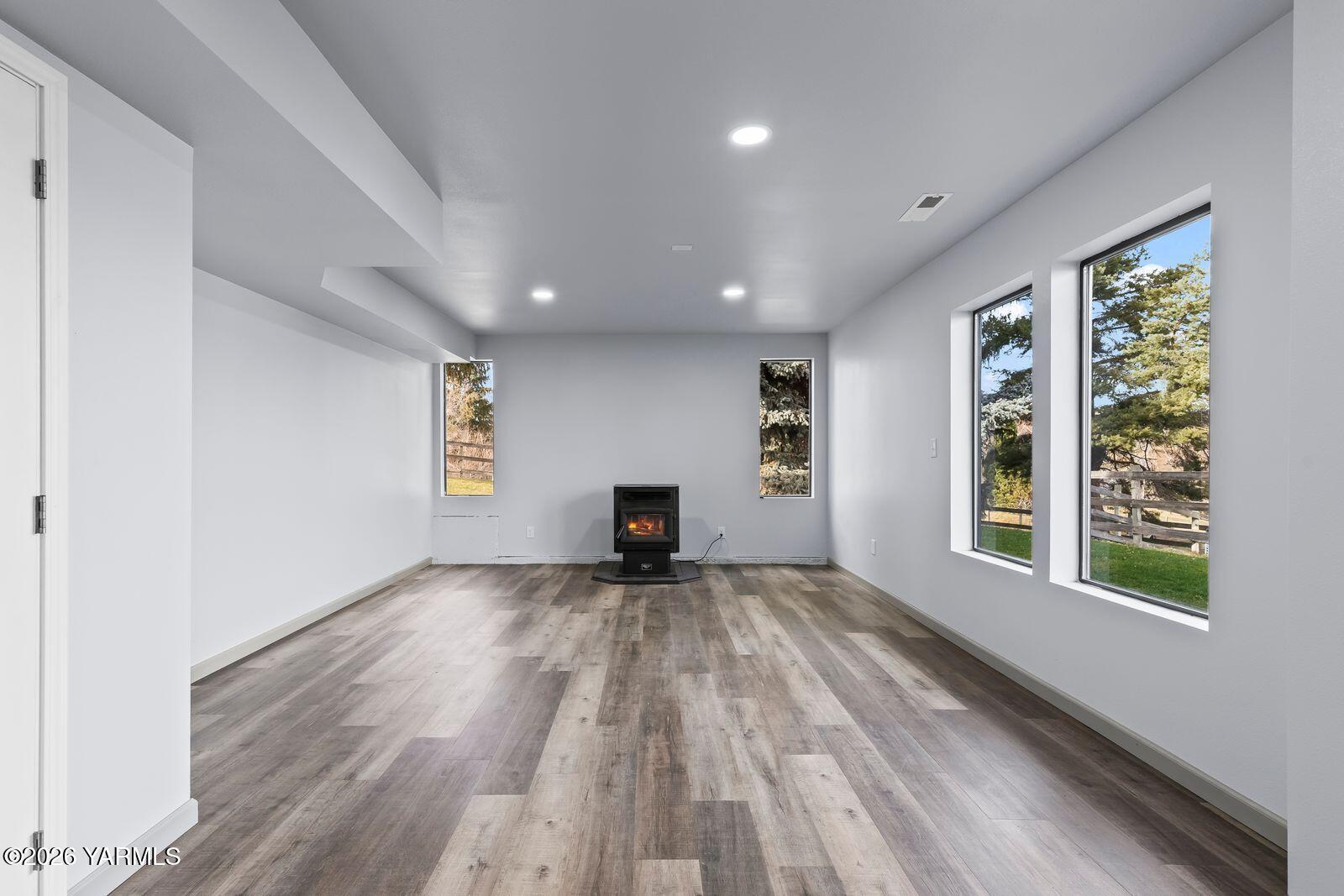 512 Taylor Road Selah, WA 98942 - Photo 23 of 36 a view of an empty room with a window and wooden floor