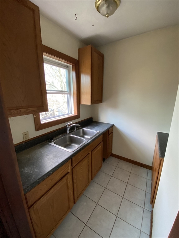 10 Lafayette Street, Unit 2 Attleboro, MA 02703 - Photo 5 of 9 a kitchen with a sink a stove cabinets and a window