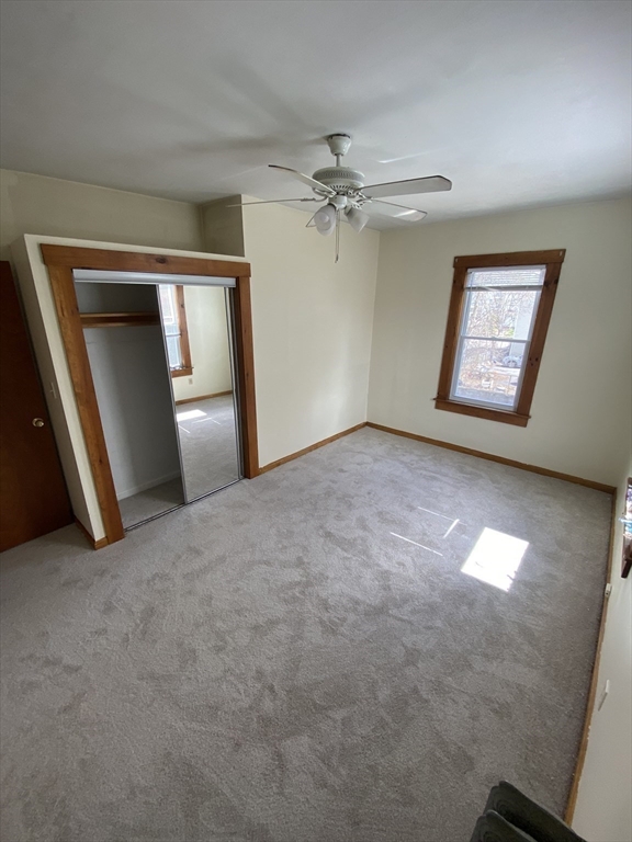 10 Lafayette Street, Unit 2 Attleboro, MA 02703 - Photo 6 of 9 an empty room with closet and a chandelier fan