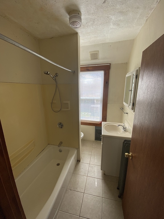 10 Lafayette Street, Unit 2 Attleboro, MA 02703 - Photo 7 of 9 a bathroom with a tub a sink and a shower