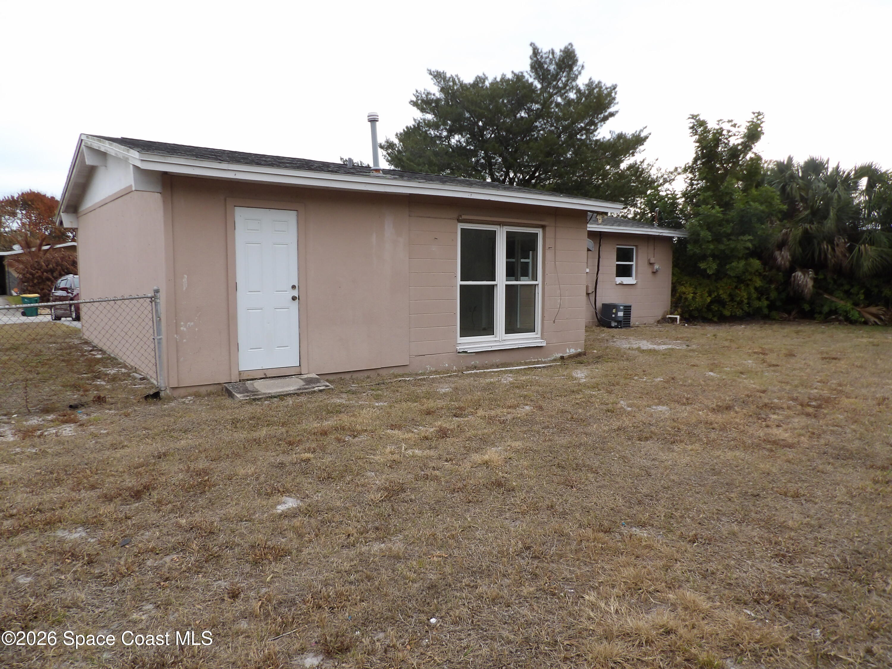 2107 Little John Road Melbourne, FL 32935 - Photo 13 of 13 a house with trees in the background