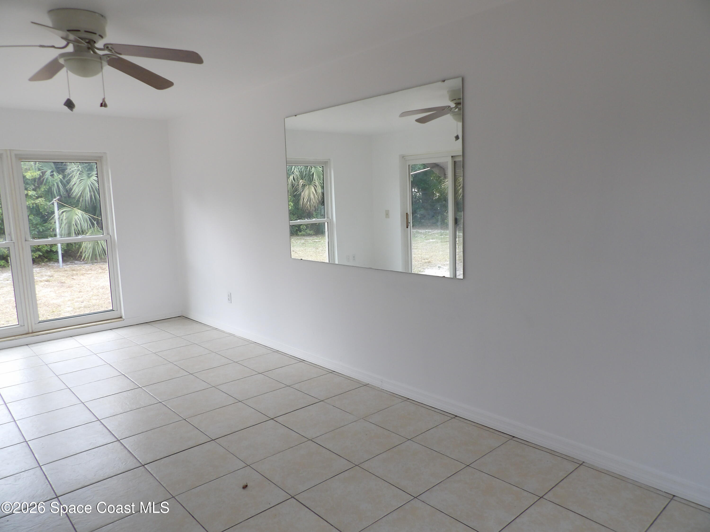 2107 Little John Road Melbourne, FL 32935 - Photo 2 of 13 a view of an empty room with a window