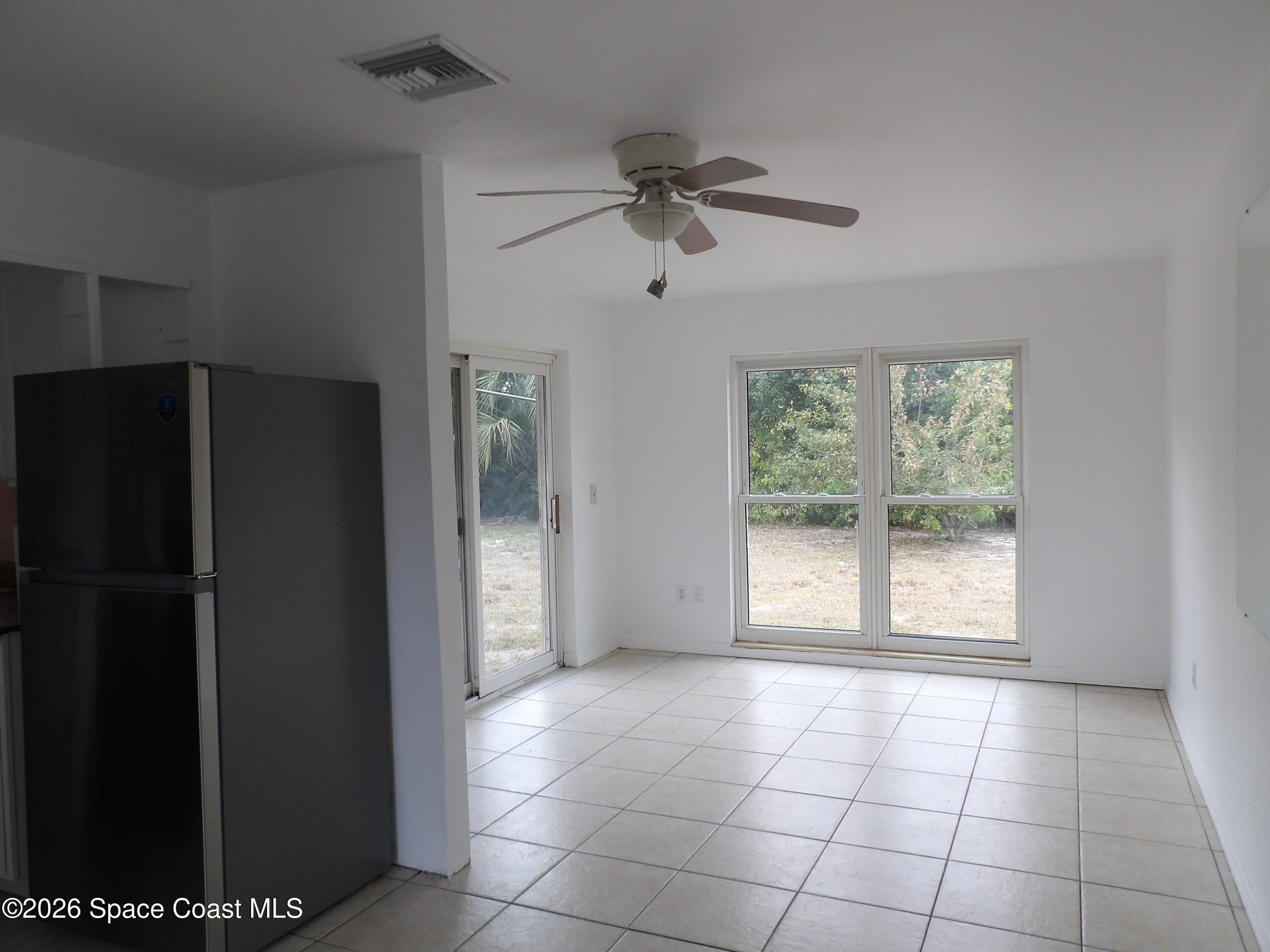 2107 Little John Road Melbourne, FL 32935 - Photo 3 of 13 a view of an empty room with a window