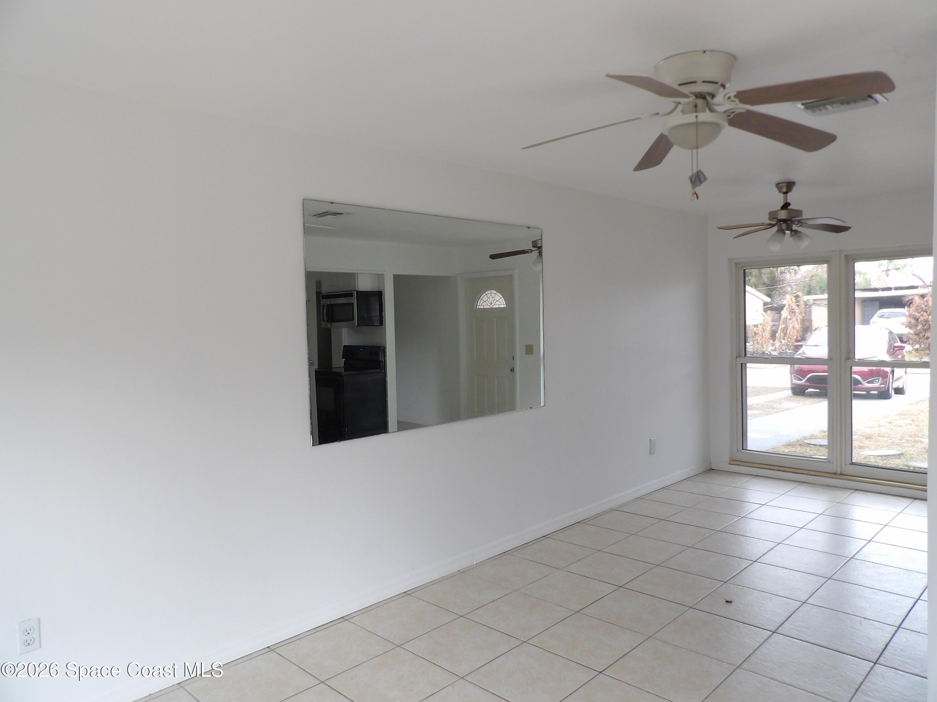 2107 Little John Road Melbourne, FL 32935 - Photo 4 of 13 a view of an empty room with a window