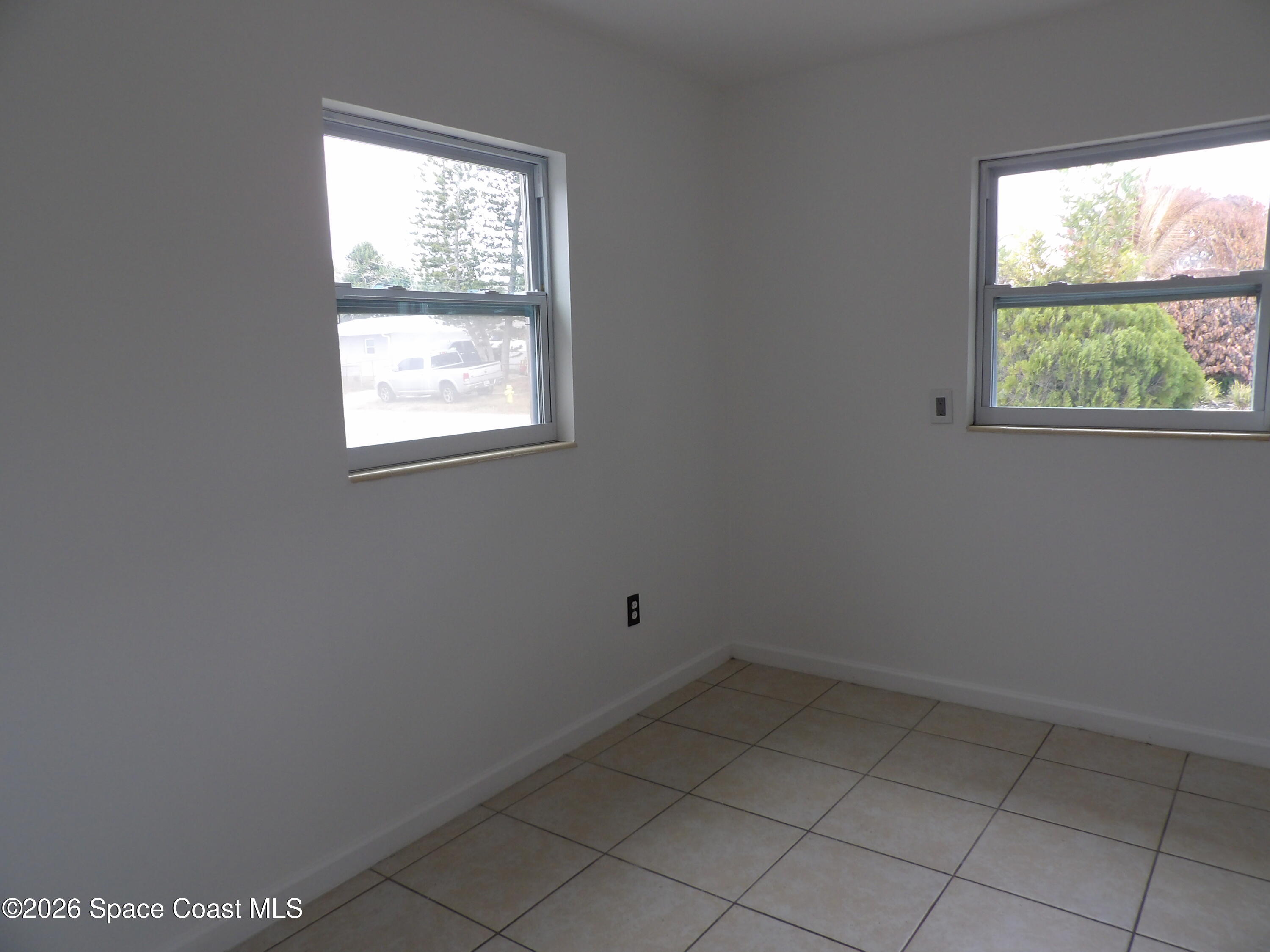 2107 Little John Road Melbourne, FL 32935 - Photo 7 of 13 an empty room with a window