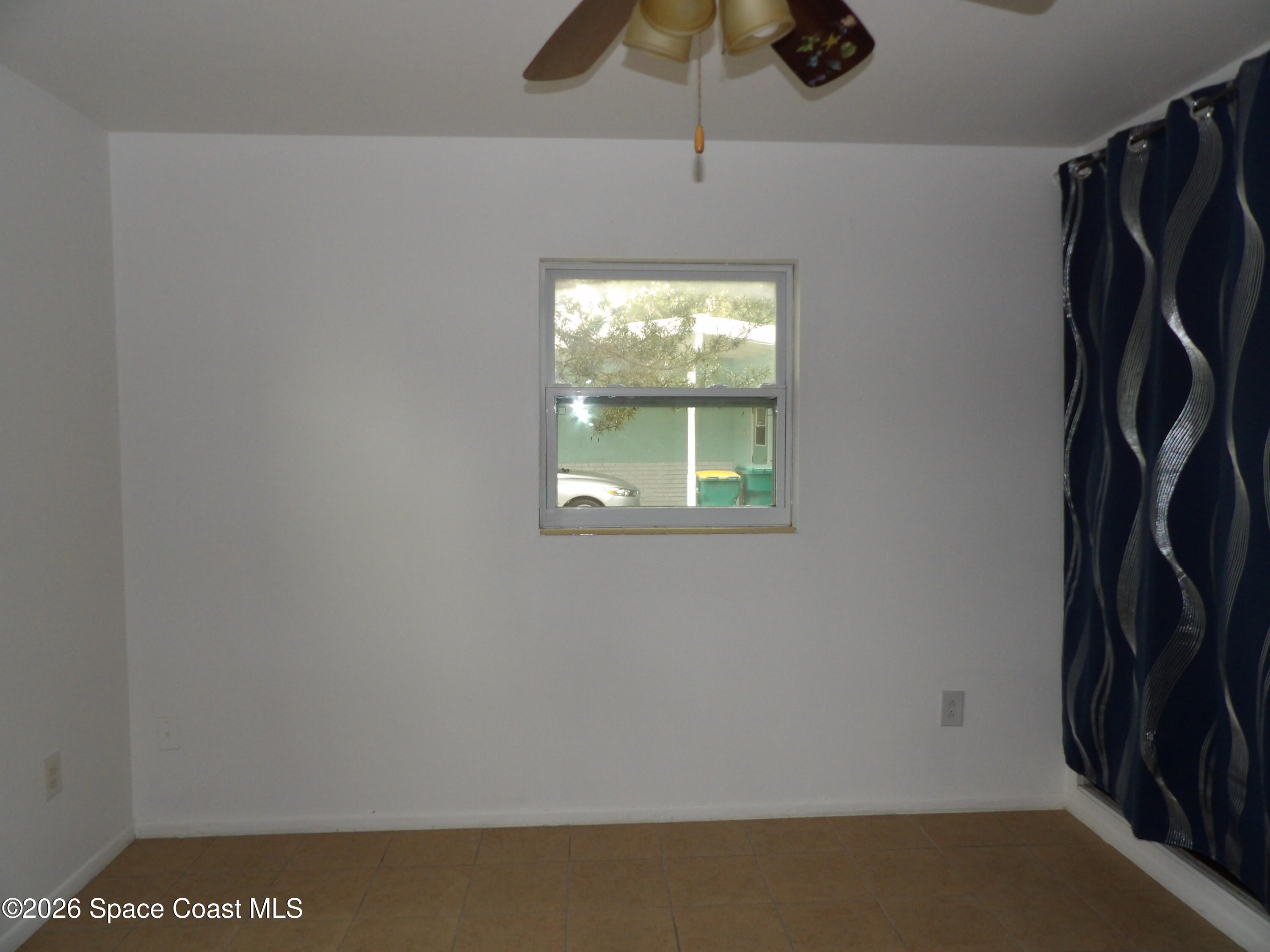 2107 Little John Road Melbourne, FL 32935 - Photo 10 of 13 a view of a livingroom with a window