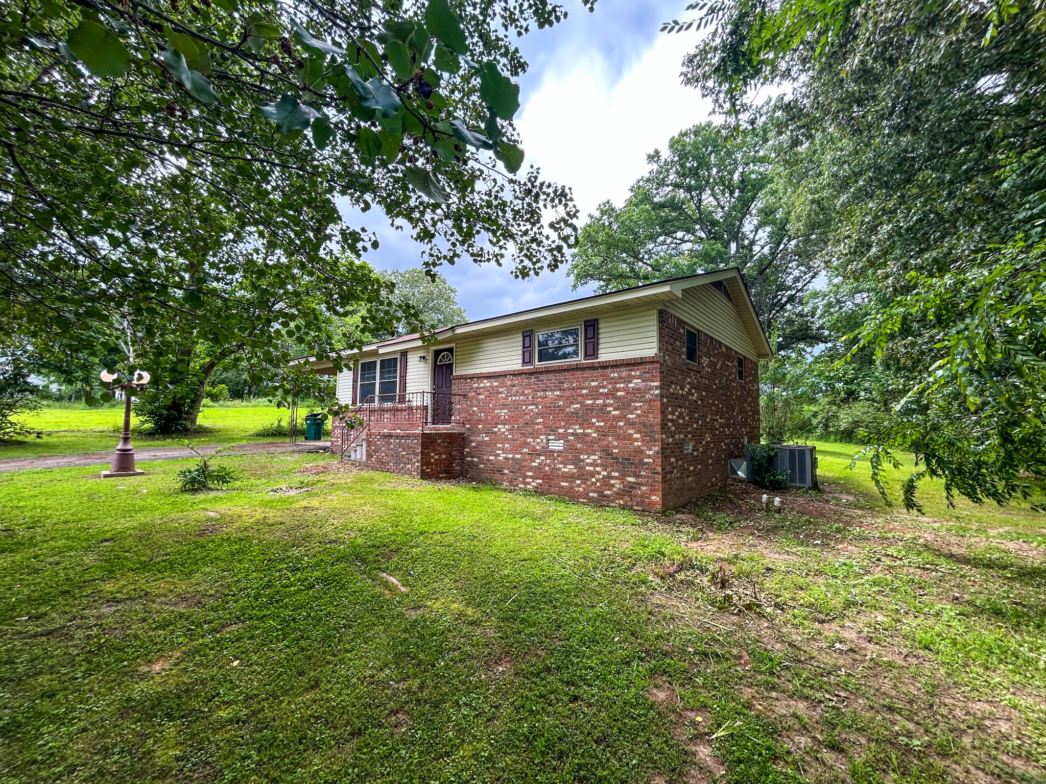 181 Jones Street Huntingdon, TN 38344 - Photo 7 of 21 a view of a yard in front of a house with large trees