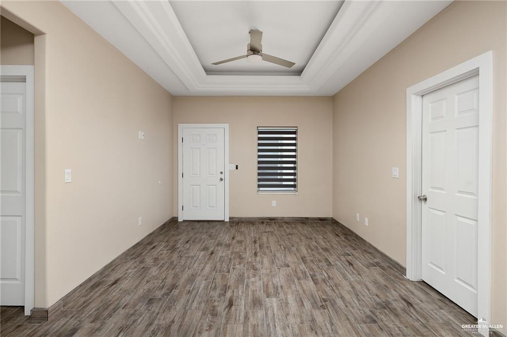 1809 Ramirez Street, Unit 2 Mission, TX 78573 - Photo 4 of 11 wooden floor in an empty room with a window