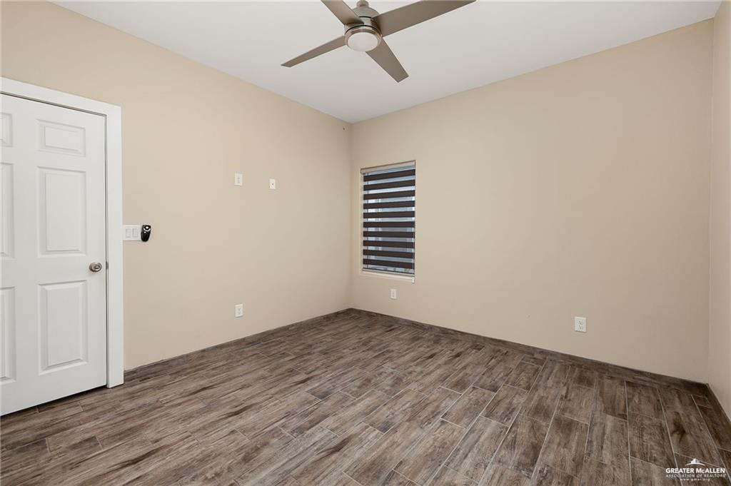 1809 Ramirez Street, Unit 2 Mission, TX 78573 - Photo 7 of 11 wooden floor in an empty room with a window