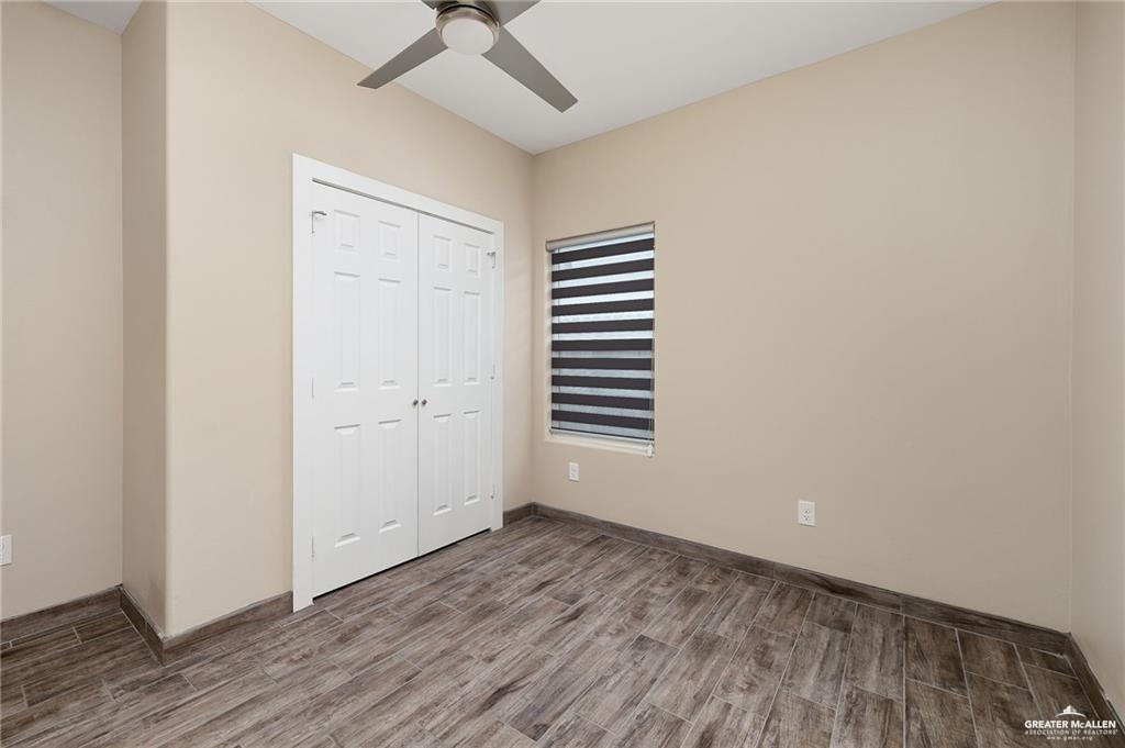1809 Ramirez Street, Unit 2 Mission, TX 78573 - Photo 9 of 11 an empty room with wooden floor and windows