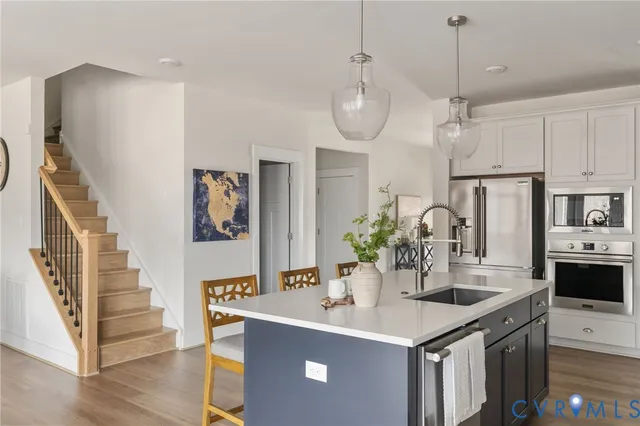 a view of center kitchen island and stainless steel appliances