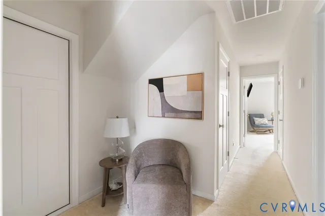a view of living room with a wooden floor and a mirror