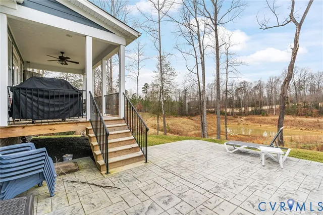 a view of a swimming pool with a patio and a yard