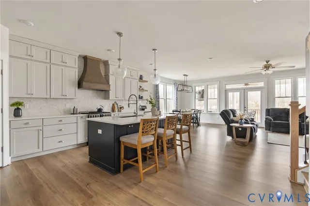 a room with lots of wooden furniture a desk and chairs