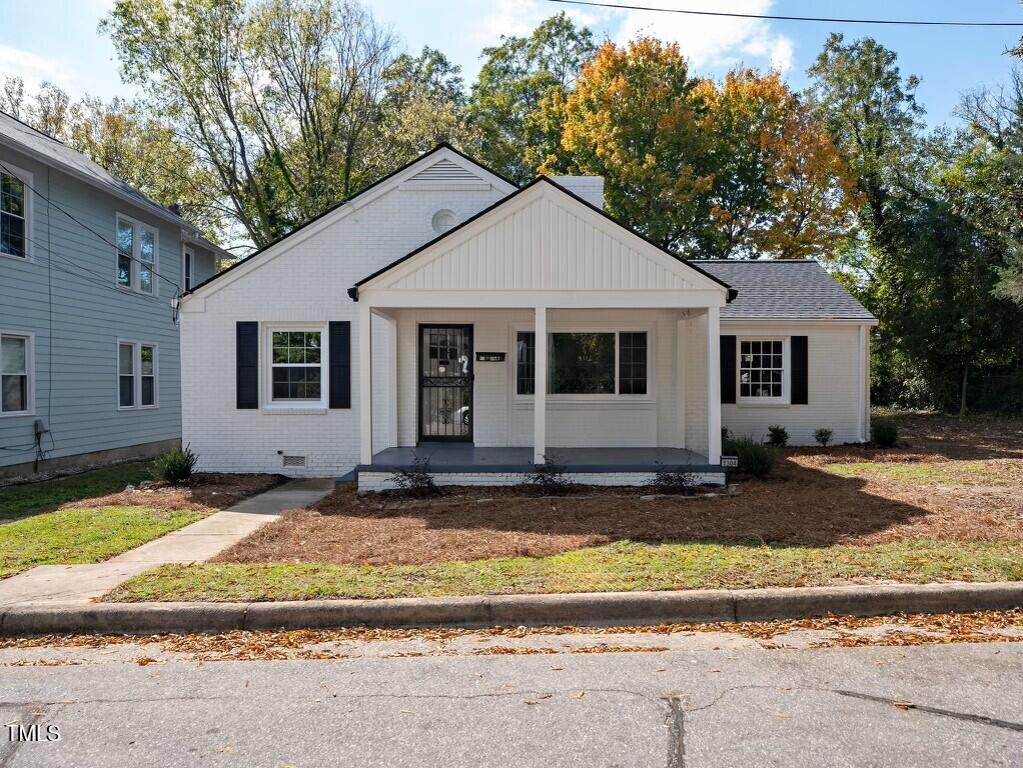 1304 East Jones Street Raleigh, NC 27610 - Photo 1 of 12 a view of a house with backyard and trees in the background