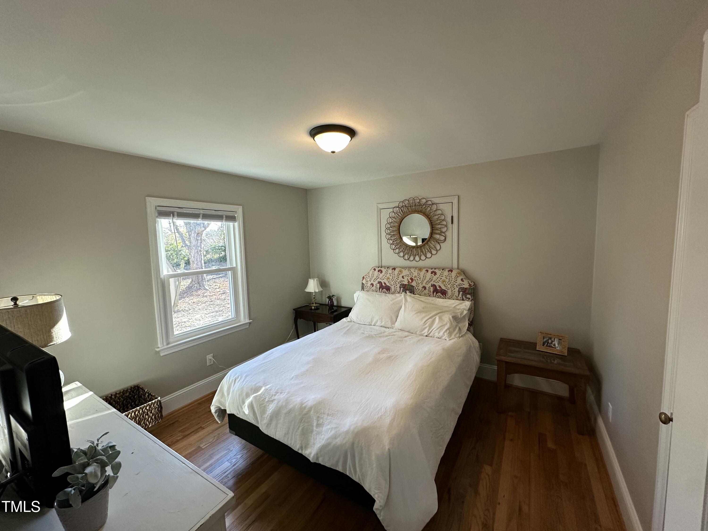 1304 East Jones Street Raleigh, NC 27610 - Photo 8 of 12 a bedroom with a bed and a window