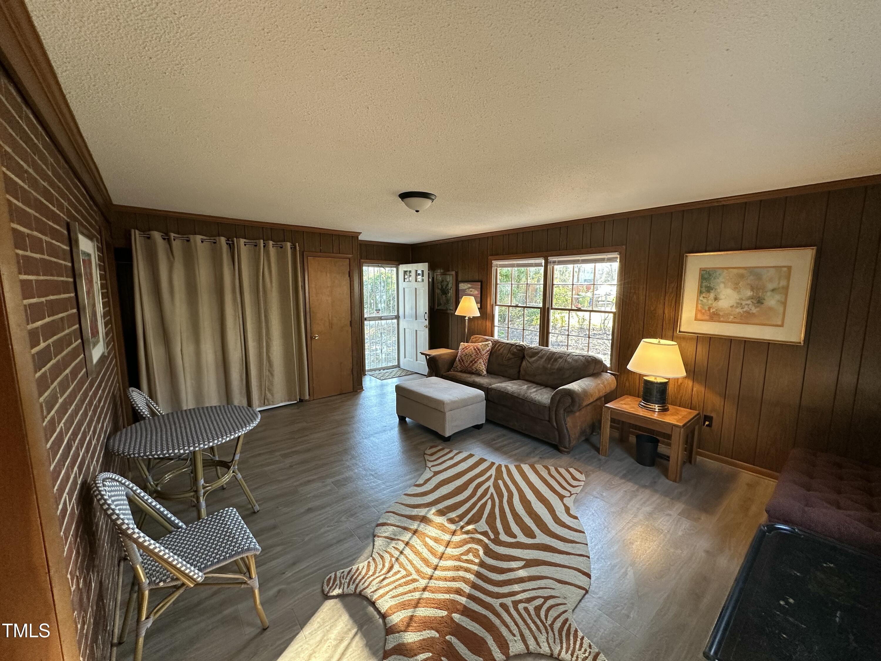 1304 East Jones Street Raleigh, NC 27610 - Photo 10 of 12 a living room with furniture and a large window