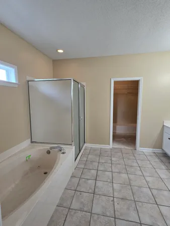 a bathroom with a bathtub and a shower