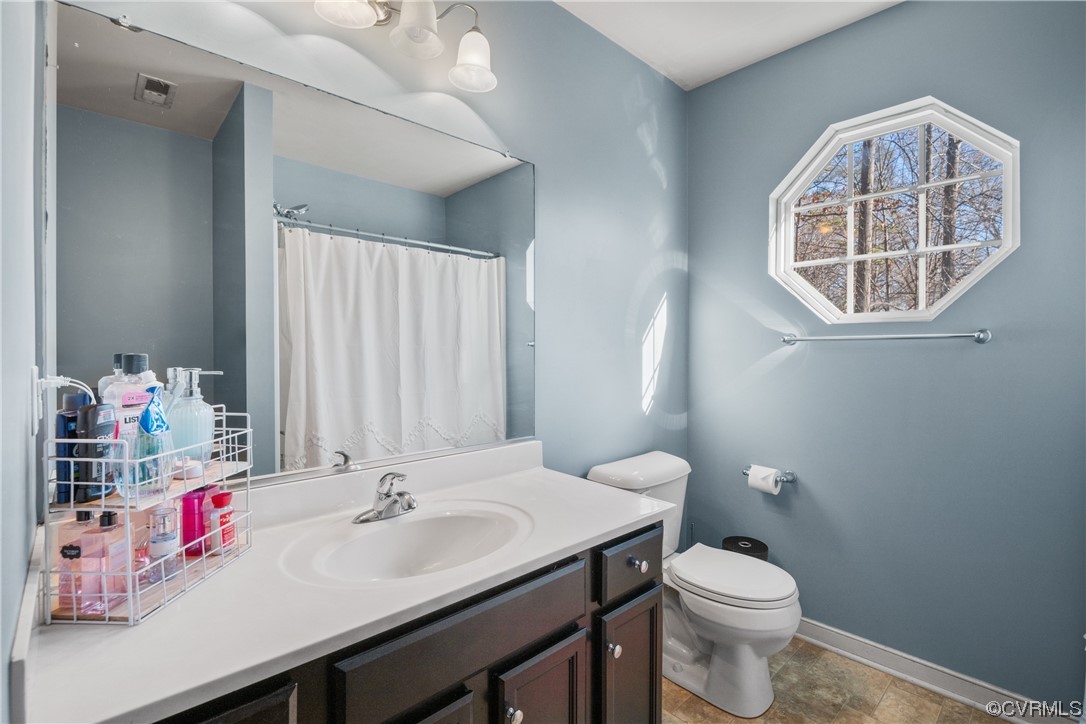 1700 Hybla Road North Chesterfield, VA 23236 - Photo 29 of 37 a bathroom with a sink a toilet and a mirror