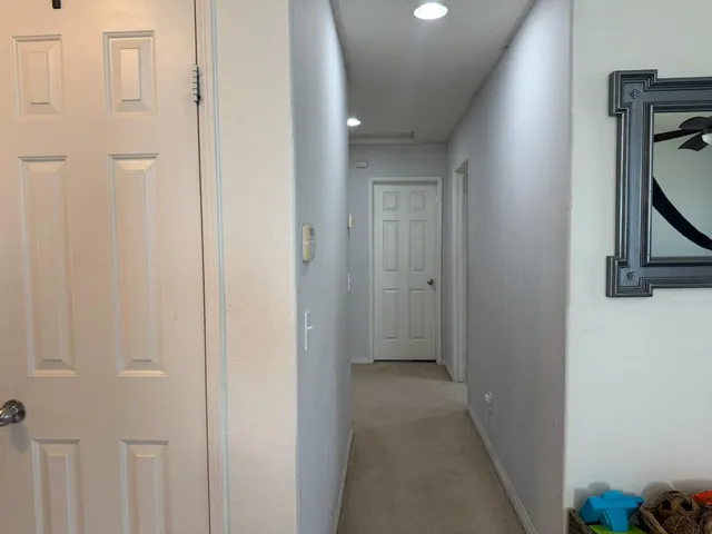 a bathroom with a granite countertop toilet sink and mirror