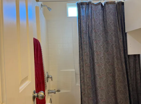 a view of room with a ceiling fan and window