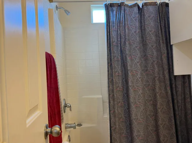 a view of room with a ceiling fan and window