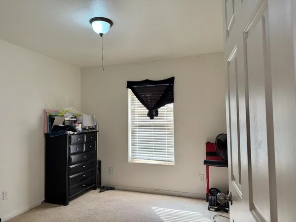 a view of a livingroom with furniture and a window