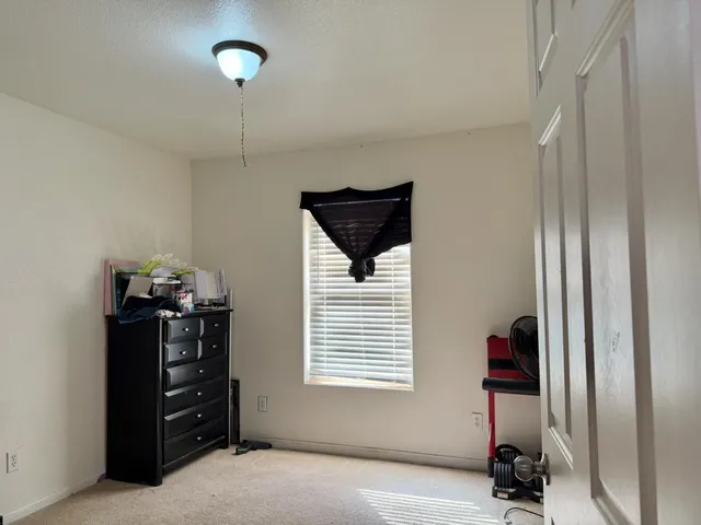 a view of a livingroom with furniture and a window