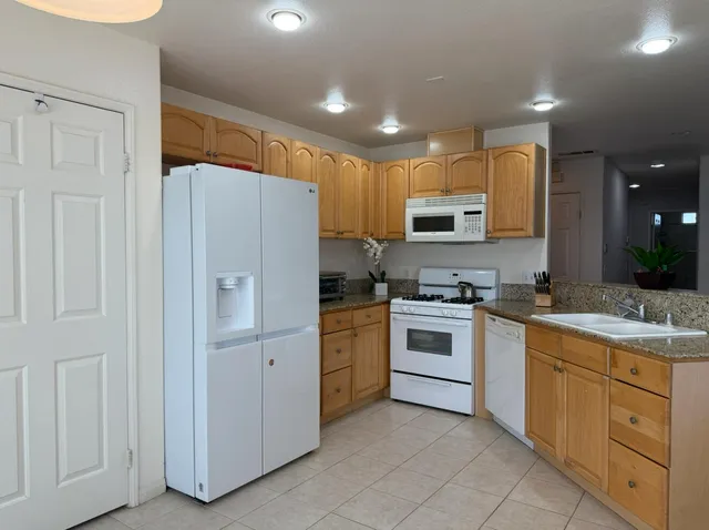 a kitchen with a sink stove and microwave
