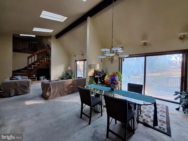 a view of a living room with furniture and a flat screen tv