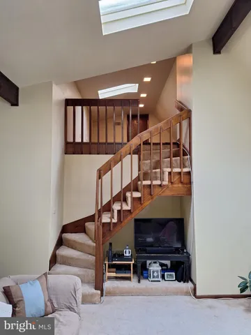 a view of entryway with wooden floor and stairs