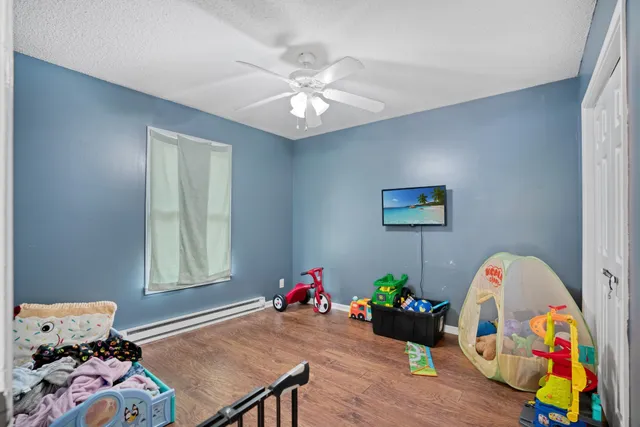 a room with pool table and ceiling fan