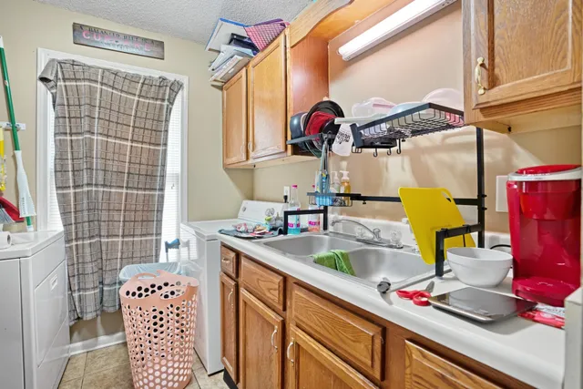 a bathroom with a sink a toilet and shower curtain