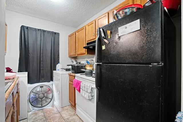 a kitchen with a stove and a refrigerator